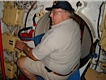 Rusty Howell trying to crawl through the hatch on the Soviet submarine