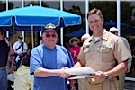 Joe Trytten is being presented a certificate for riding the LCAC by Senior Chief Darin Campbell