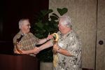 Past President Tom Bernard turning over an Indian Gavel (from an Indian medicine man) to our new President JJ Hogue